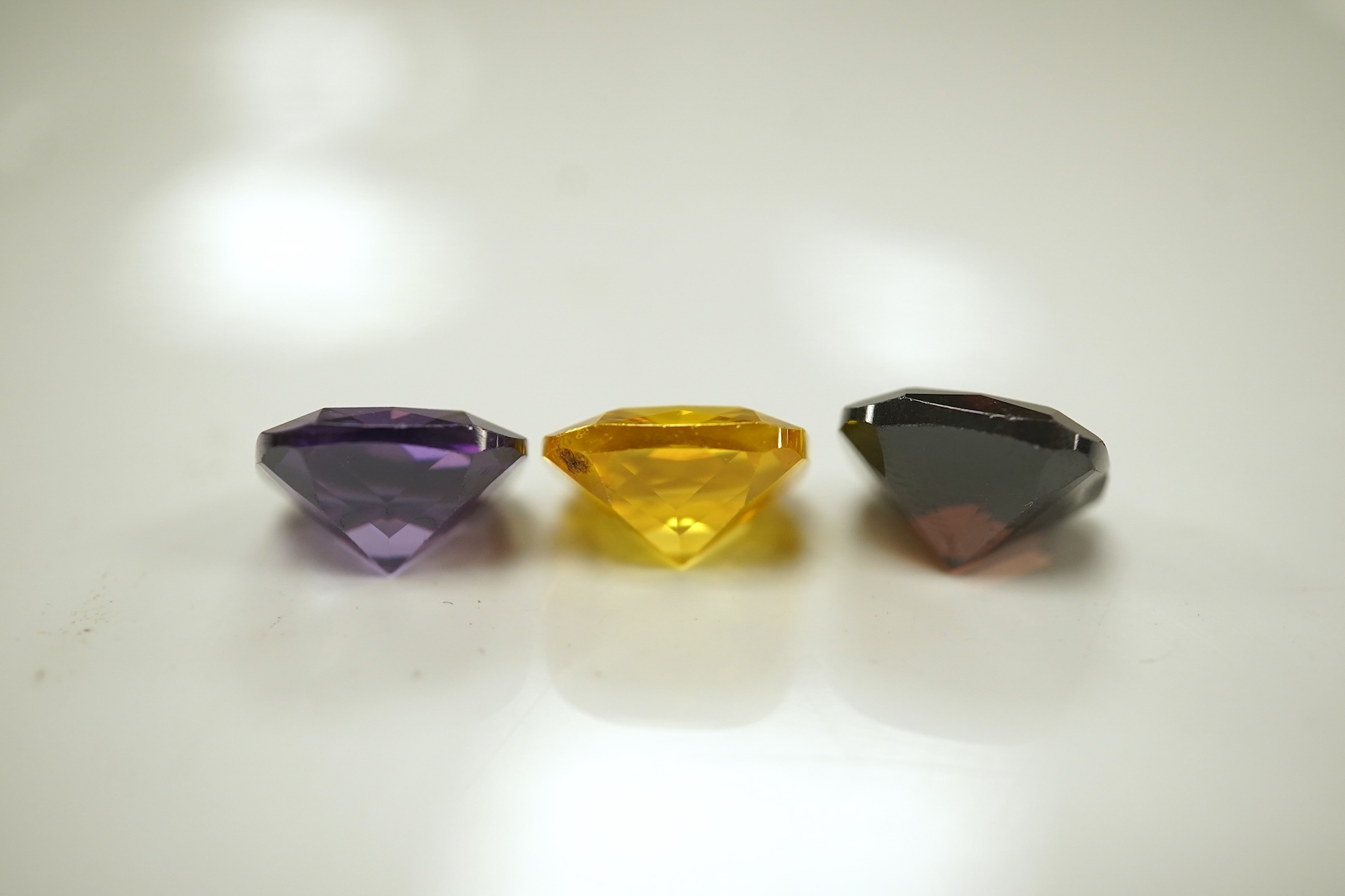 A quantity of assorted cut coloured cubic zirconia stones. Condition - poor to fair to good